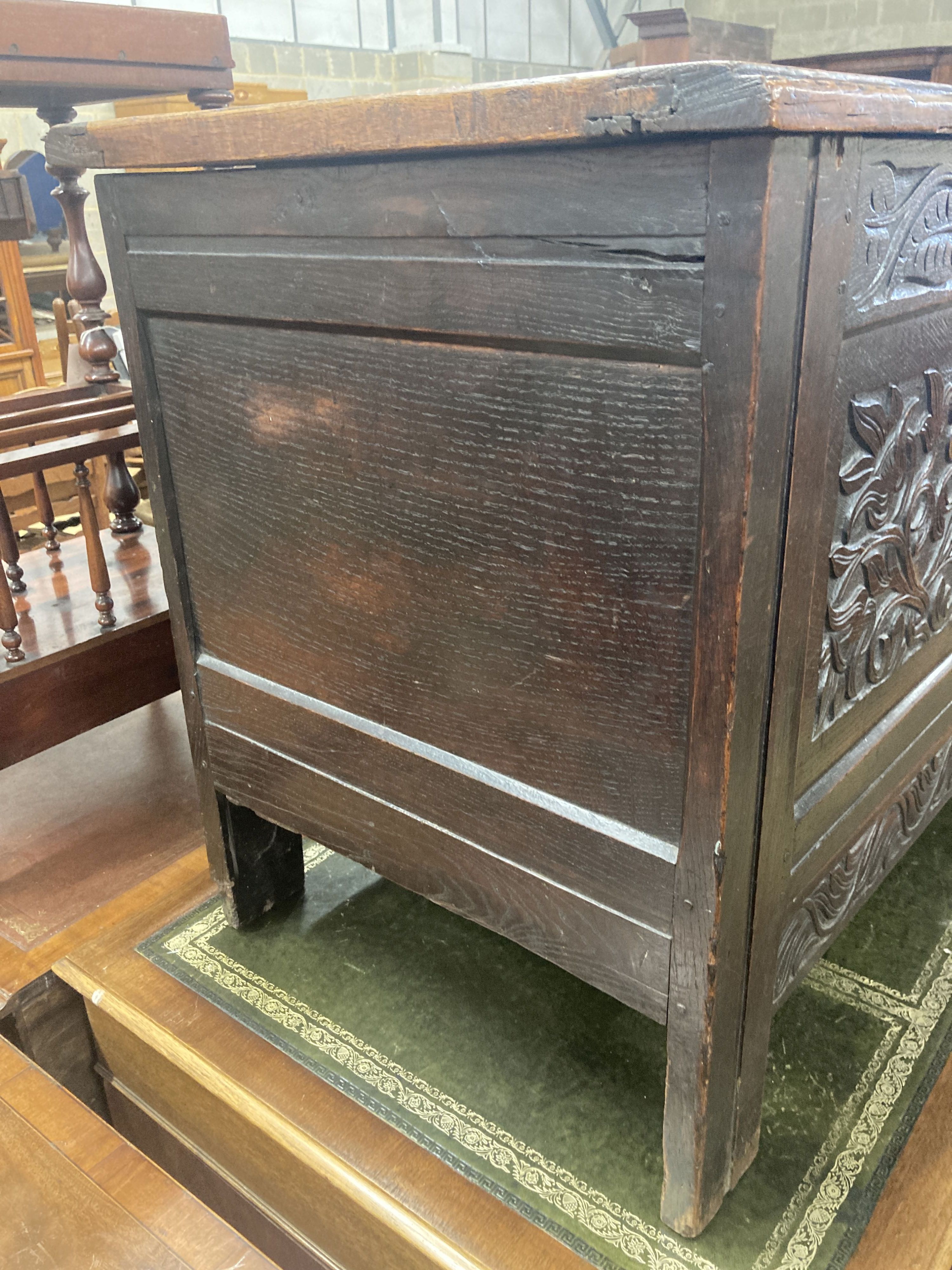 An 18th century carved panelled oak coffer, fitted drawer, length 130cm, depth 58cm, height 75cm